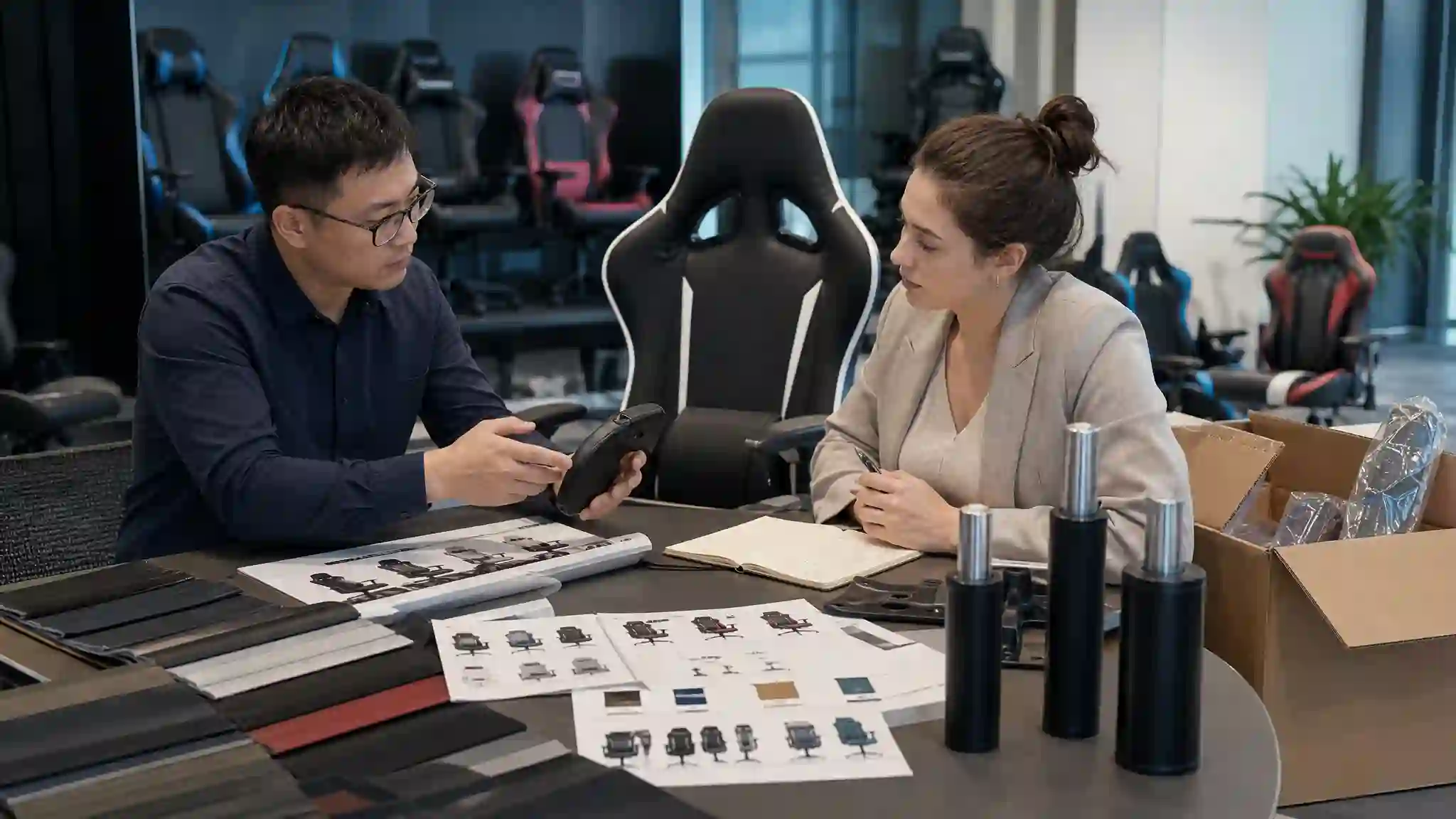 B2B buyers reviewing gaming chair samples and gas lift specifications before bulk order