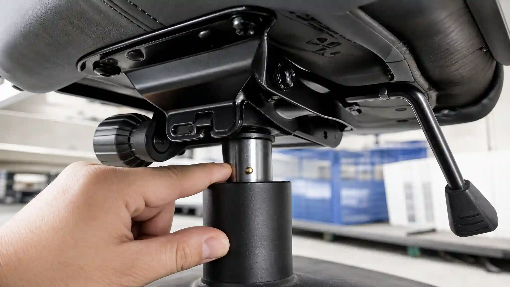 Close up inspection of gaming chair height lever and gas lift valve pin clearance