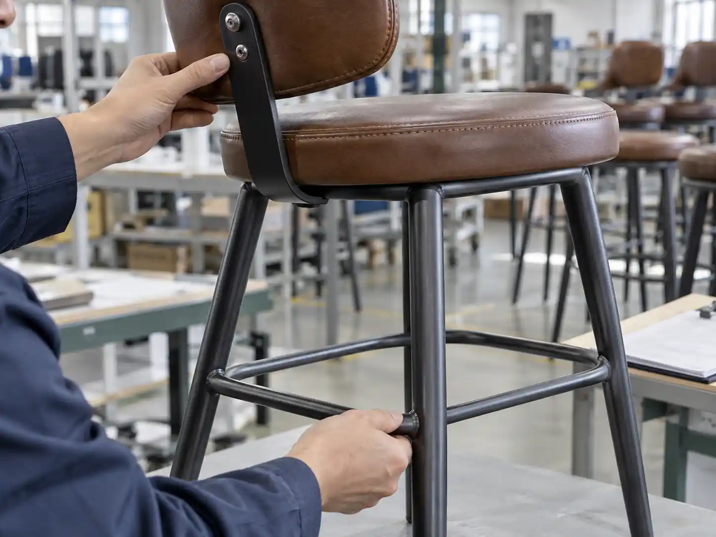Close inspection of a commercial bar stool backrest joint and footrest structure