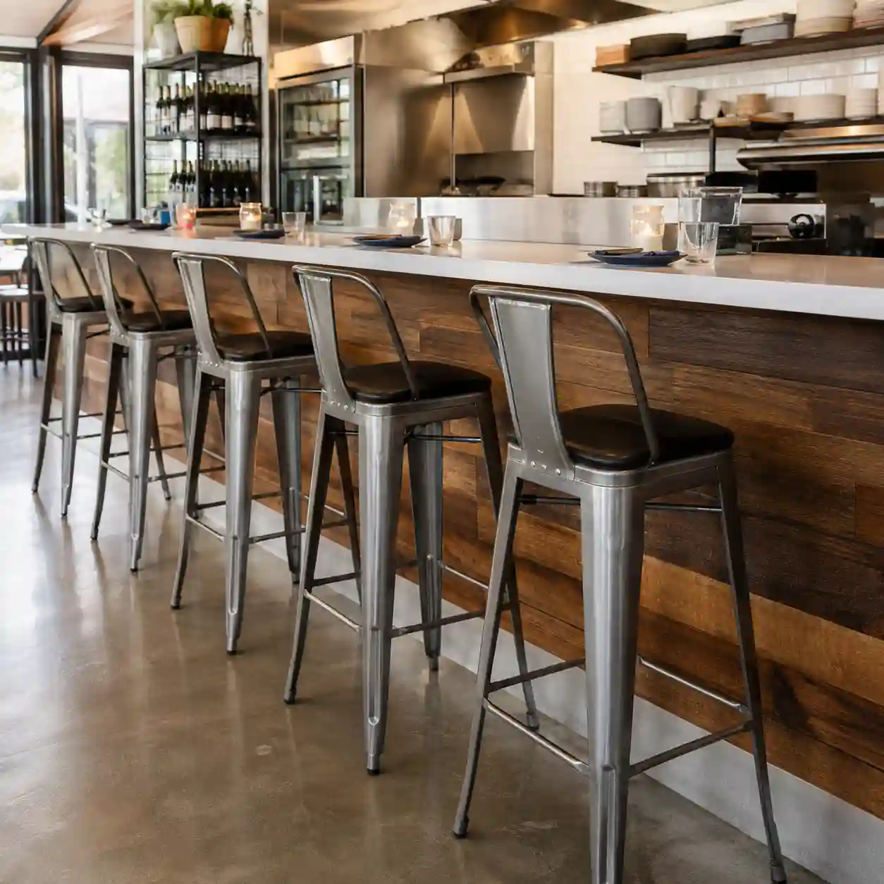 Metal counter height bar stools arranged at a restaurant counter for a commercial project